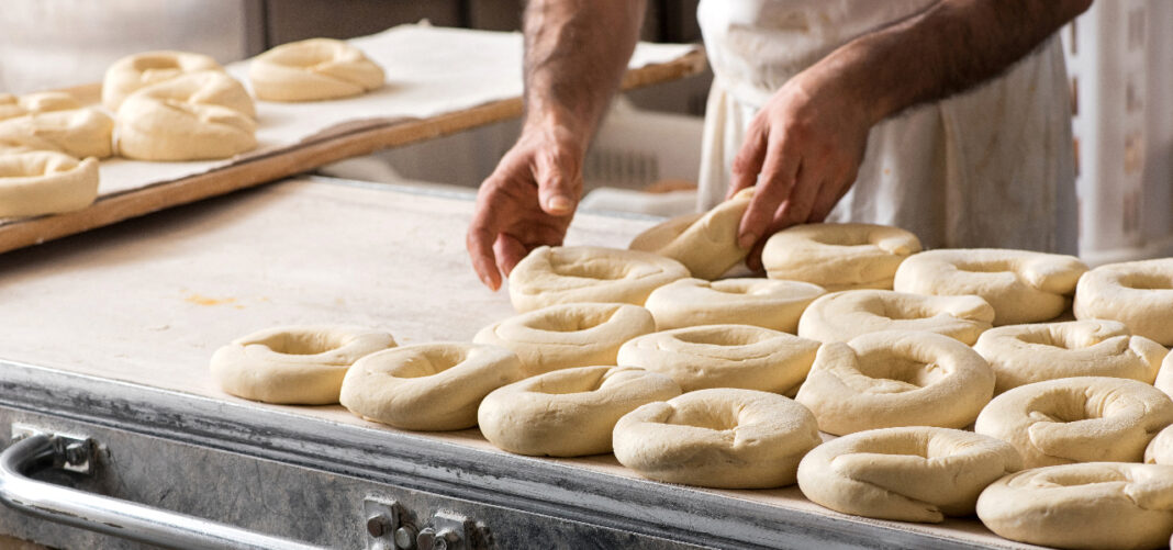 Baker preparing dough for bagels